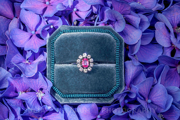 Red ruby ring with diamonds inside a velvet box