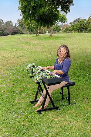Woman in park playing her keyboard